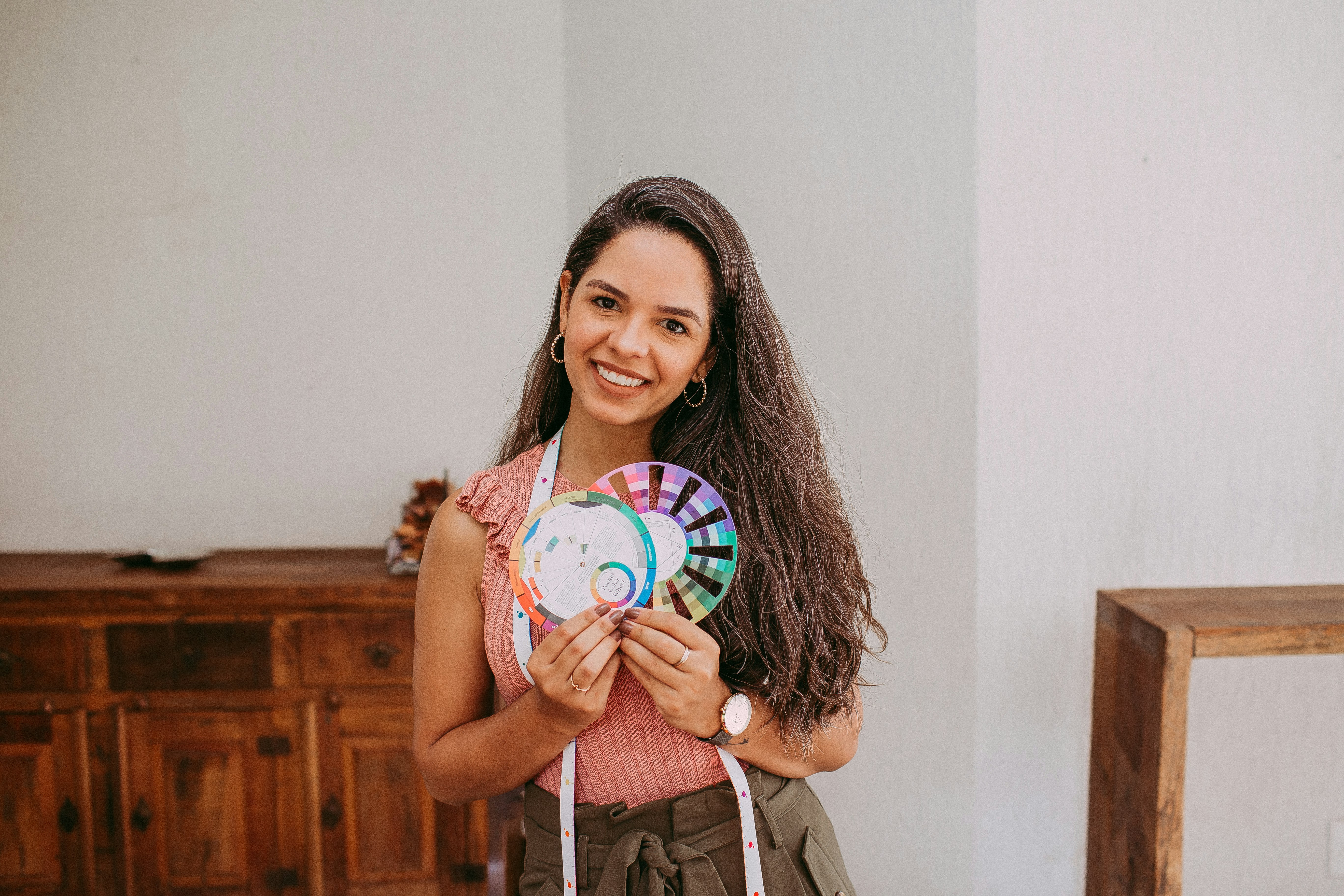 woman in white tank top holding white blue and green mickey mouse printed ball